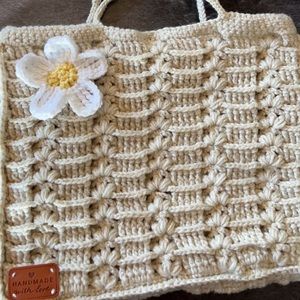 Handmade crochet tote bag with flower on top
